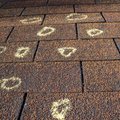 Hail dents on a metal roof panel inspected by Platinum Home Exteriors