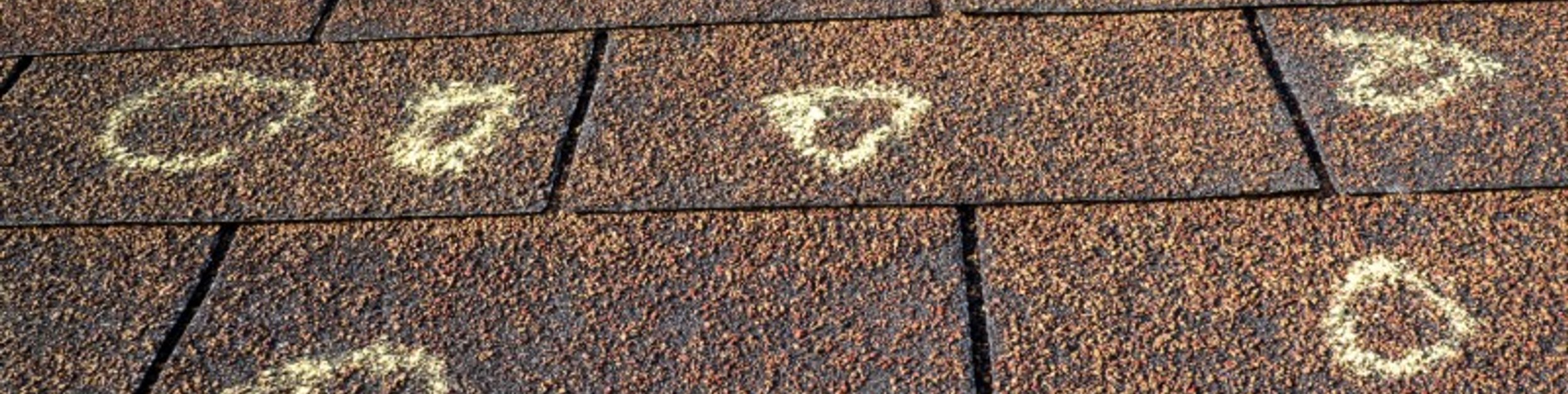 Hail dents on a metal roof panel inspected by Platinum Home Exteriors
