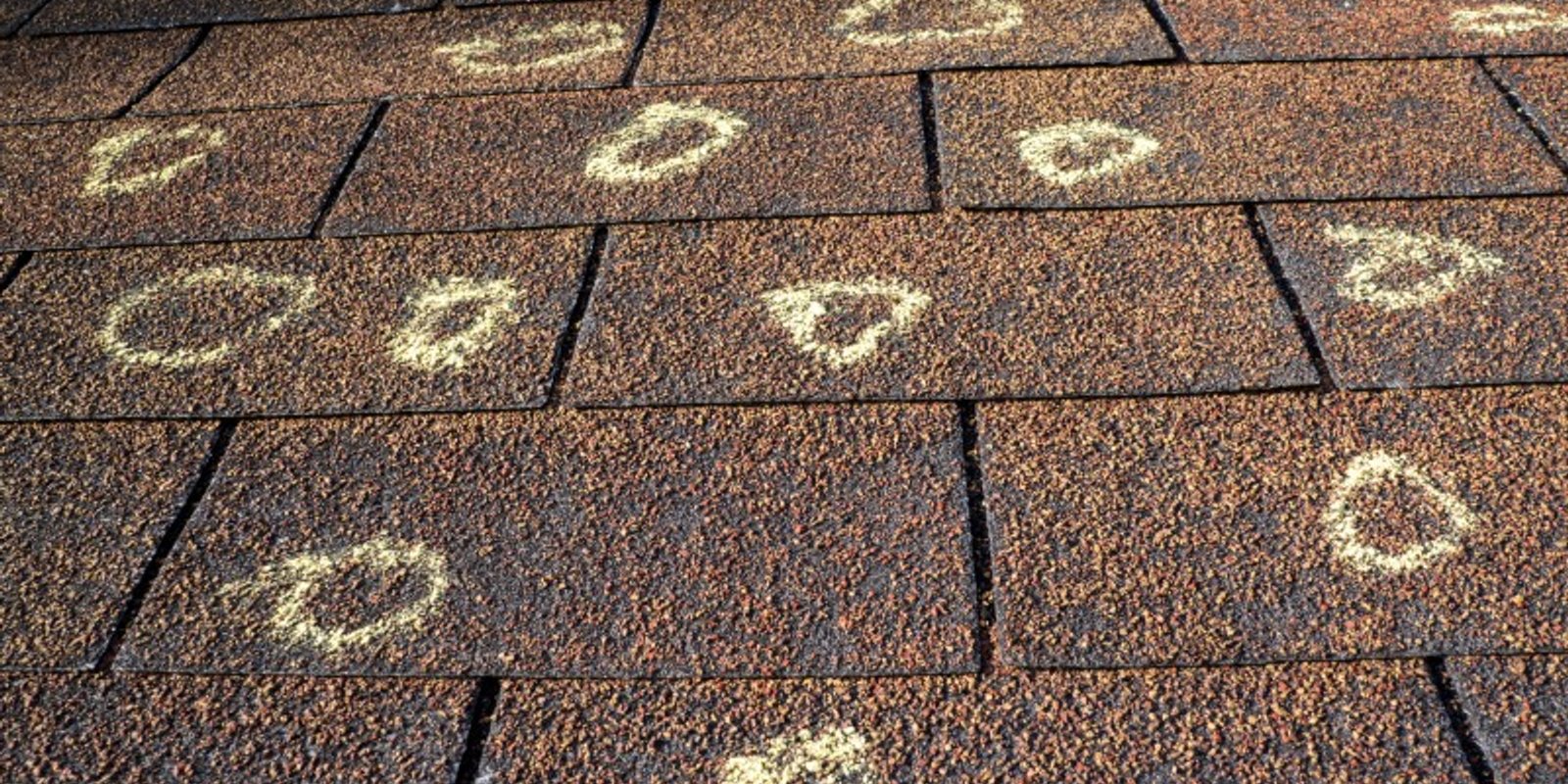 Hail dents on a metal roof panel inspected by Platinum Home Exteriors