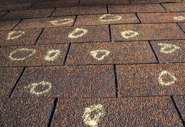 Roof inspected by Platinum Home Exteriors for storm damage showing hail impact and denting