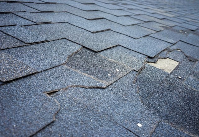 Roof inspected by Platinum Home Exteriors for storm damage showing missing shingles
