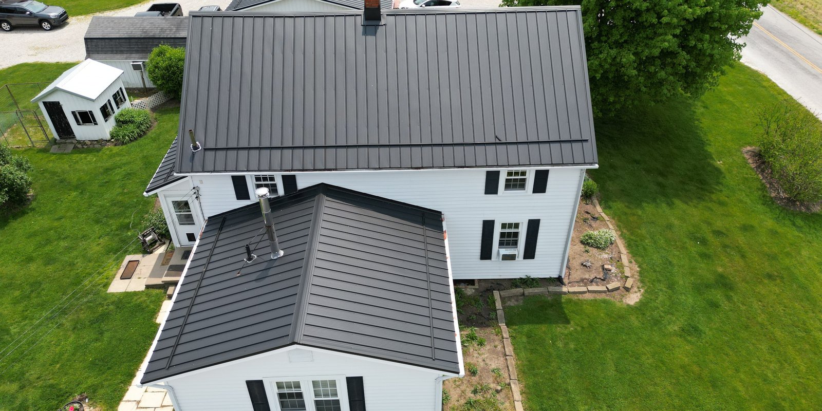 white house with a dark metal roof