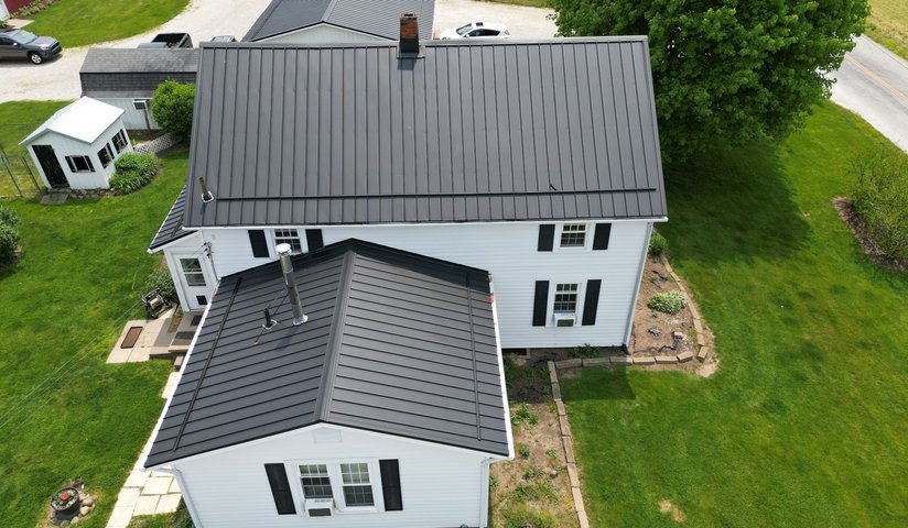 white house with a dark metal roof