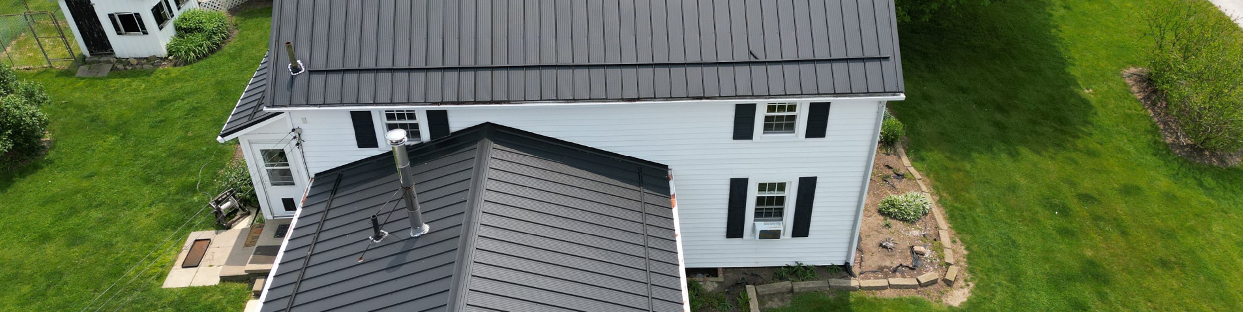 white house with a dark metal roof