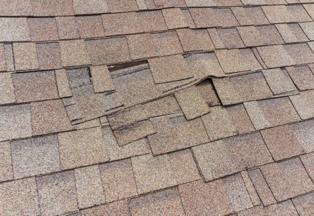 Roof inspected by Platinum Home Exteriors for storm damage showing uneven shingles