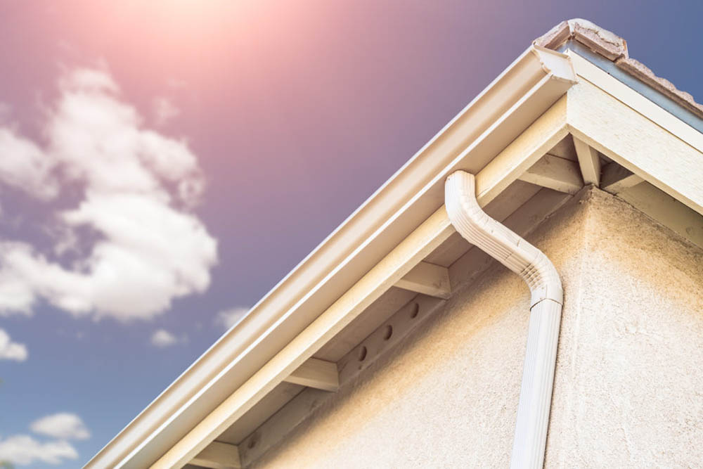 We offer gutter services. Close-up view of a gutter and down-spout.