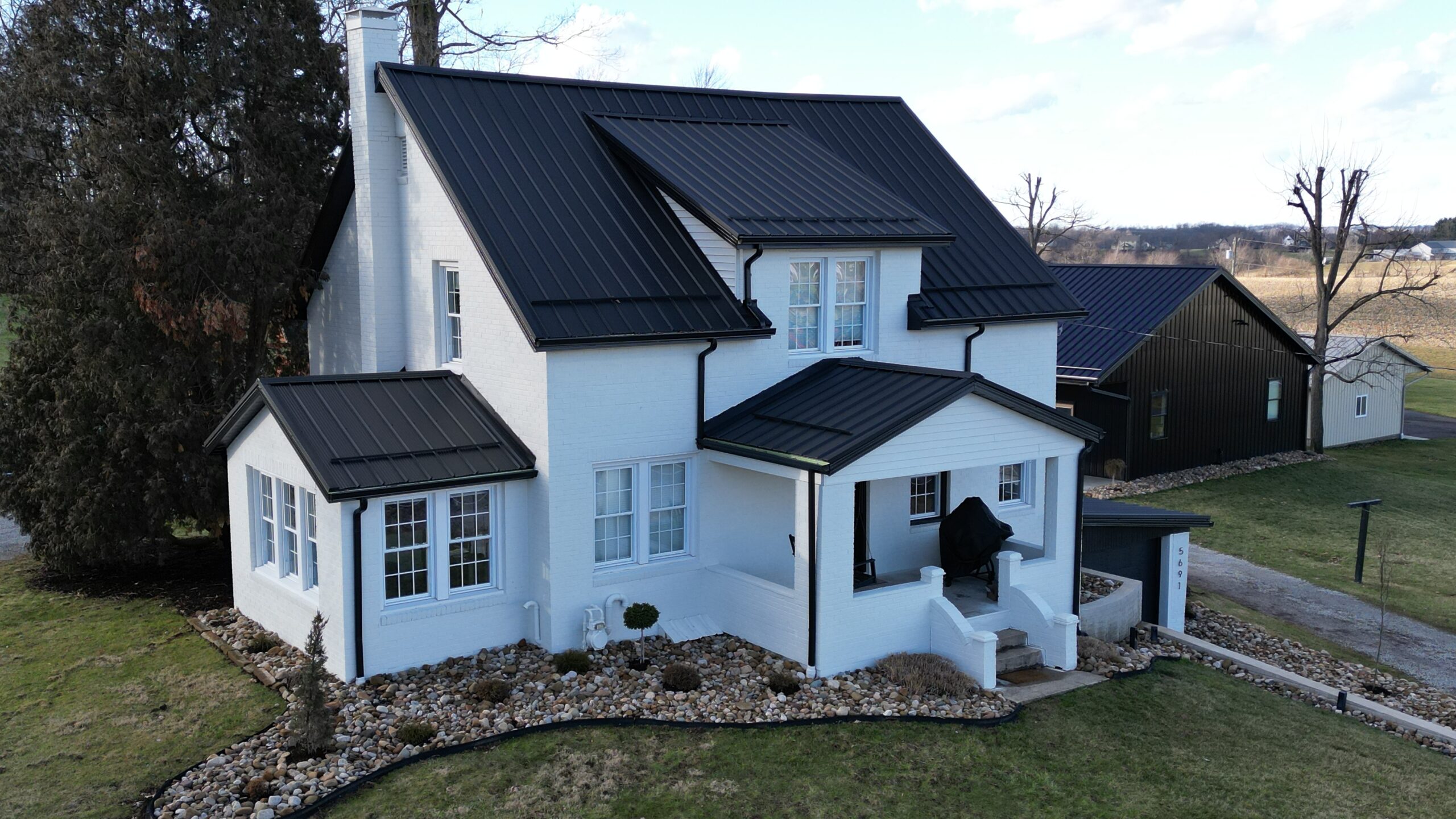A Beautiful Black Metal Roof On a White Home in Wheeling West Virginia Installed By Platinum Home Exteriors
