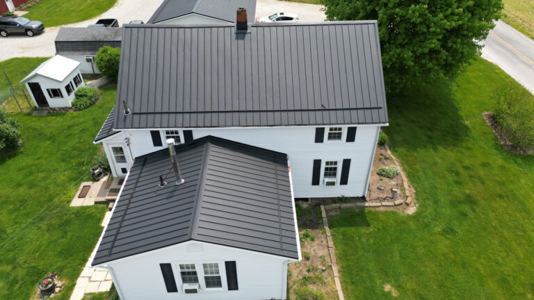 white house with a dark metal roof