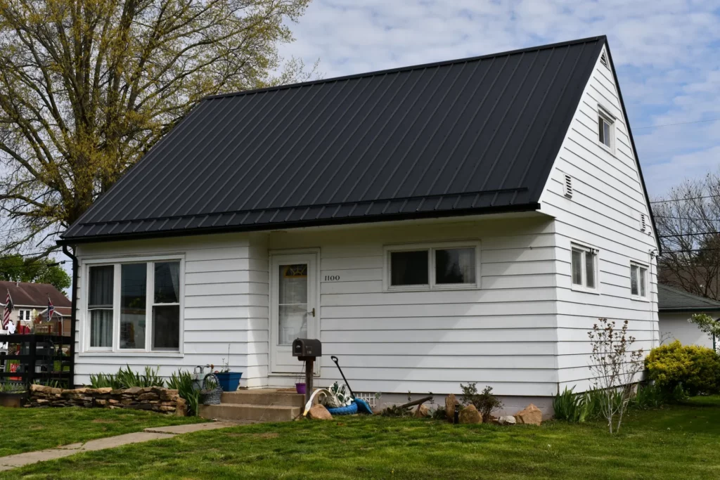 dark metal roof on a white house