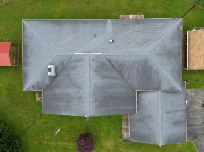 Dirty shingle roof with storm damage before repair