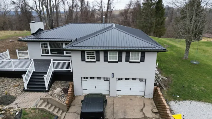 Black metal roof on a two story house built by platinum home exteriors