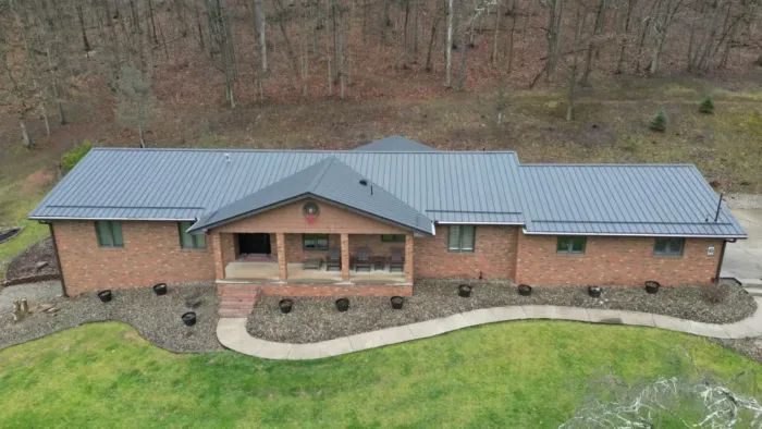 Metal roof on a brick house after roof replacement